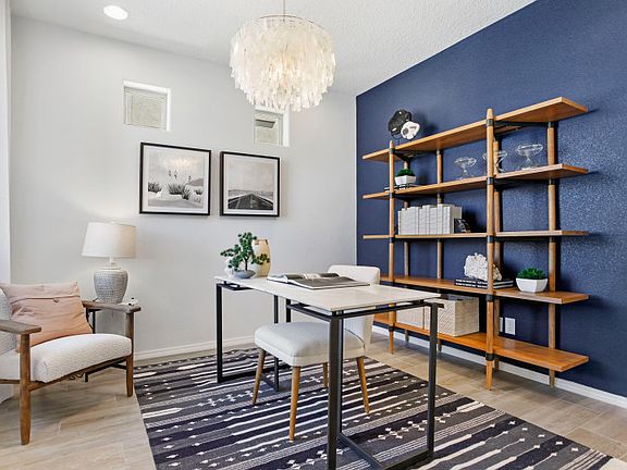 This den is a flexible room that can be used as a home office, craft room, and more