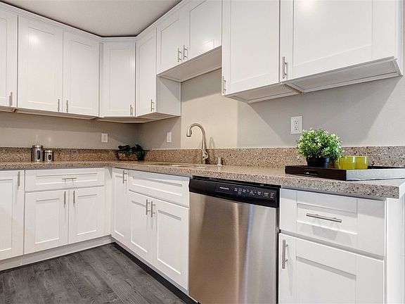 New custom kitchen with beautiful quartz counter tops, new floors & stainless steel appliances.
