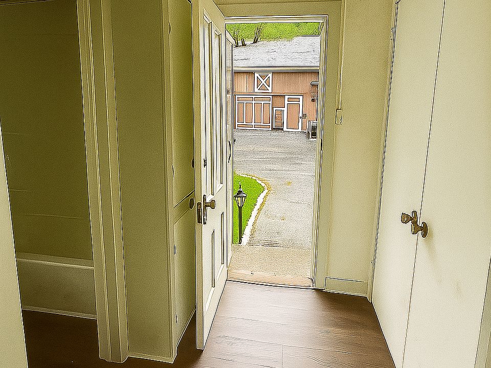 Standing in the bedroom, bathroom to the left, back door, and two storage areas on the left and right side of the hall way.