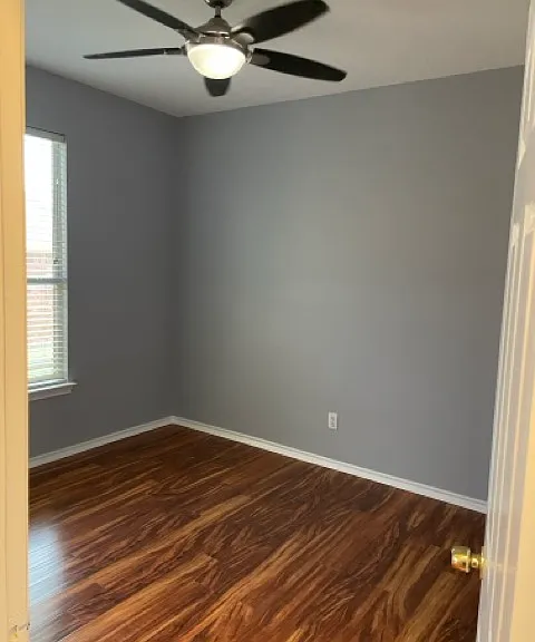3rd bedroom, ceiling fan, faces side yard of house.