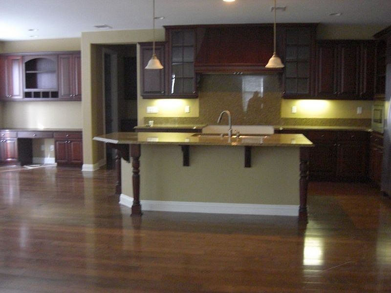 Gourmet Island Kitchen with granite counters and full granite backsplash