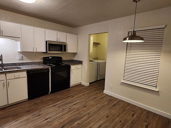 Lots of lighting in the kitchen with a window to the balcony and 2" faux wood blinds.