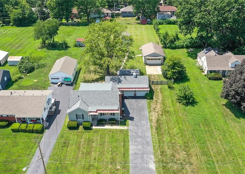 One owner home on an enormous lot with multiple outbuildings.