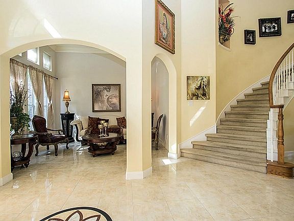 This View is From The Front Foyer Looking At The Formal Living Room To The Left; Beautiful Arched Doorways Thru Out This Lovely Home. Each Room Flows To The Next With This Open Floor Plan; But Also In This Home You Feel The Cozyness