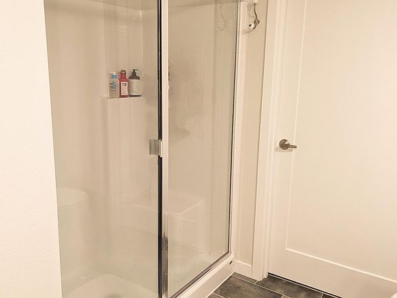 Primary shower, entrance to spacious walk-in closet.