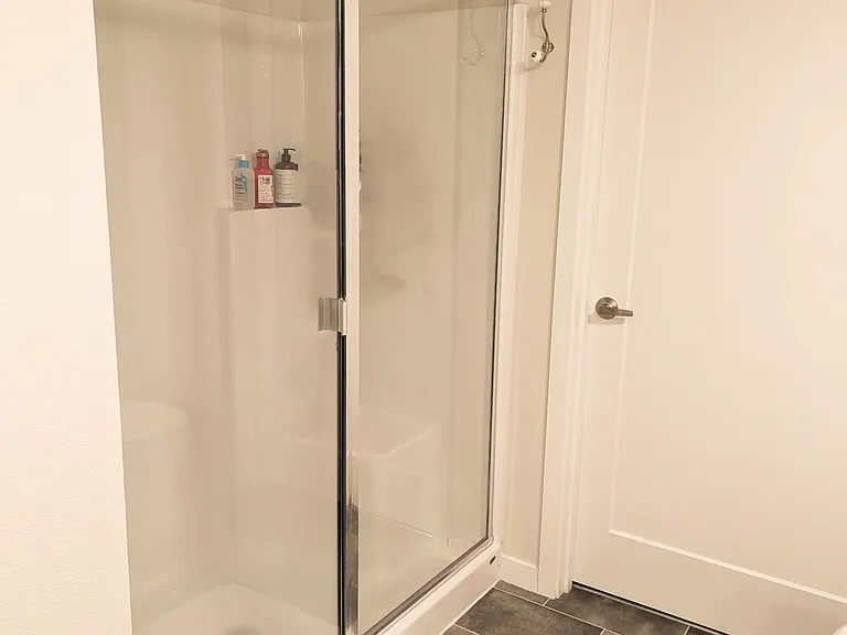 Primary shower, entrance to spacious walk-in closet.