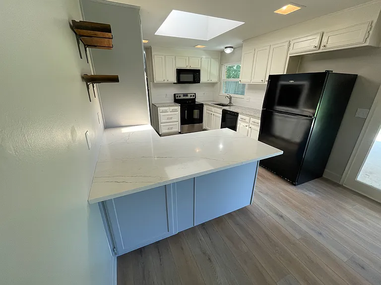 Breakfast bar doubles as prep space and serving area when entertaining
