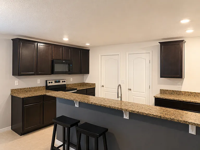 Kitchen with large enclosed pantry and door to laundry room then garage