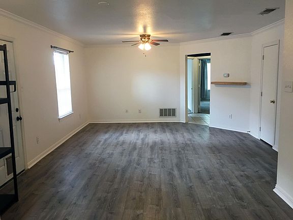 Living room area. Closet on right. Garage entrance on right (not pictured).