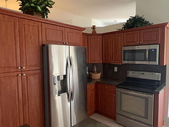 Fully equipped kitchen with stainless steel appliances, cookware, dishes and more.
