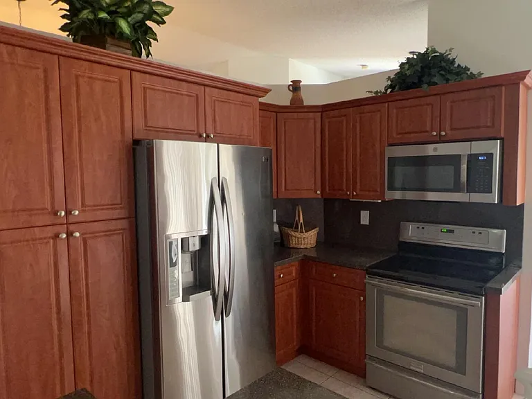 Fully equipped kitchen with stainless steel appliances, cookware, dishes and more.