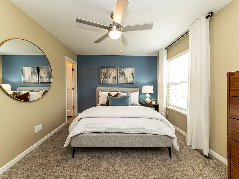 Cozy bedroom with carpet and ceiling fan