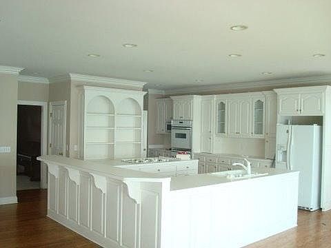 huge kitchen with lots of cabinets and a great view of the l
