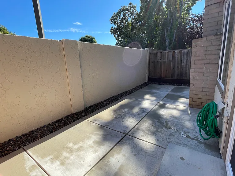 New concrete patio, with freshly painted wall.