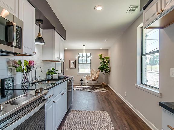 Kitchen features granite countertops and new appliances..