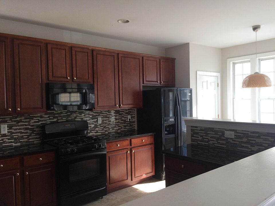 Spacious Kitchen - 1st floor. Appliances include refrigerator, oven, microwave, dish washer. Plenty of cabinets and pantry room. Newly installed marble counter top with backsplash Plenty of sunshine during the day in the breakfast area.