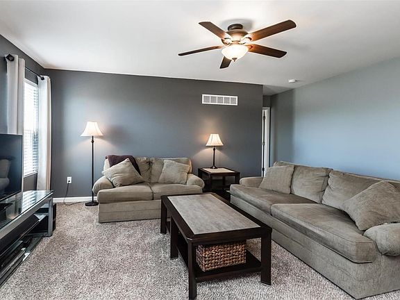 Nice family room with bright windows and newer carpet.