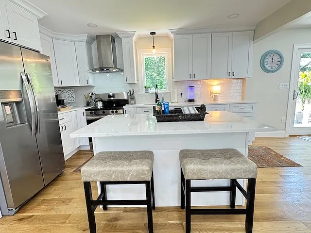 Modern and bright kitchen with extra island seating available.