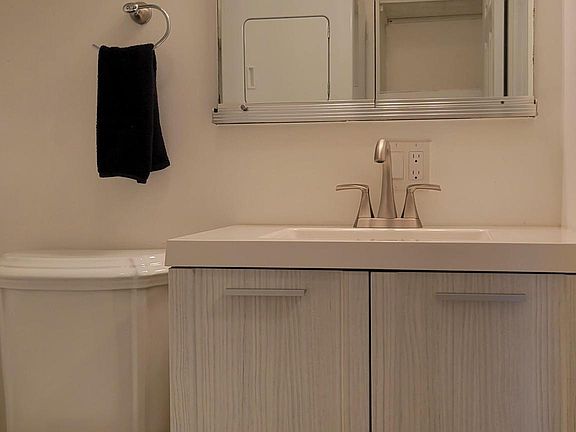 Half bathroom with wash machine and dryer on first floor