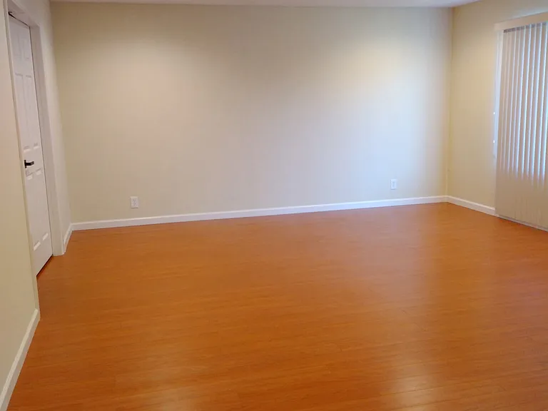 Living room with recessed LED lights and laminate wood floor