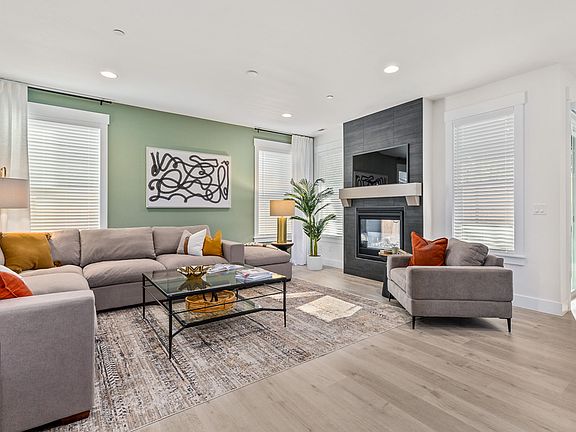 Great room is anchored by gas fireplace