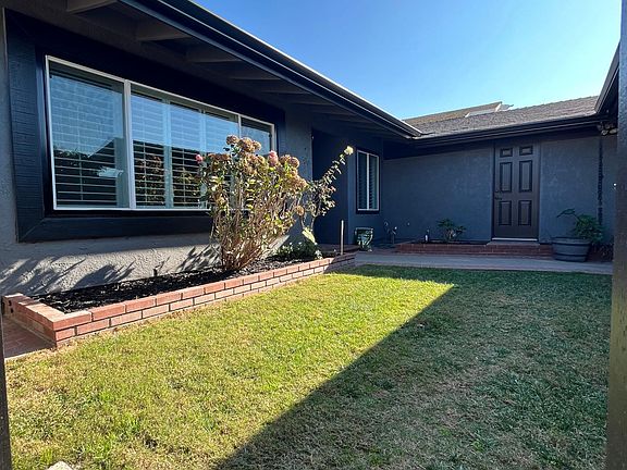 Beautiful Curb Appeal with Fresh Exterior Paint, Tropical Landscaping With Fruit Trees and courtyard