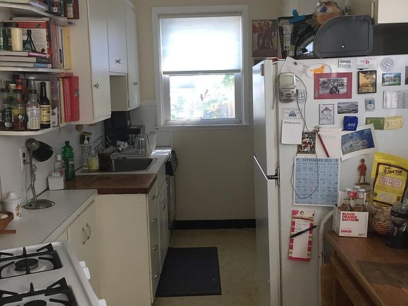 gallley kitchen next to open kitchen space for a table'