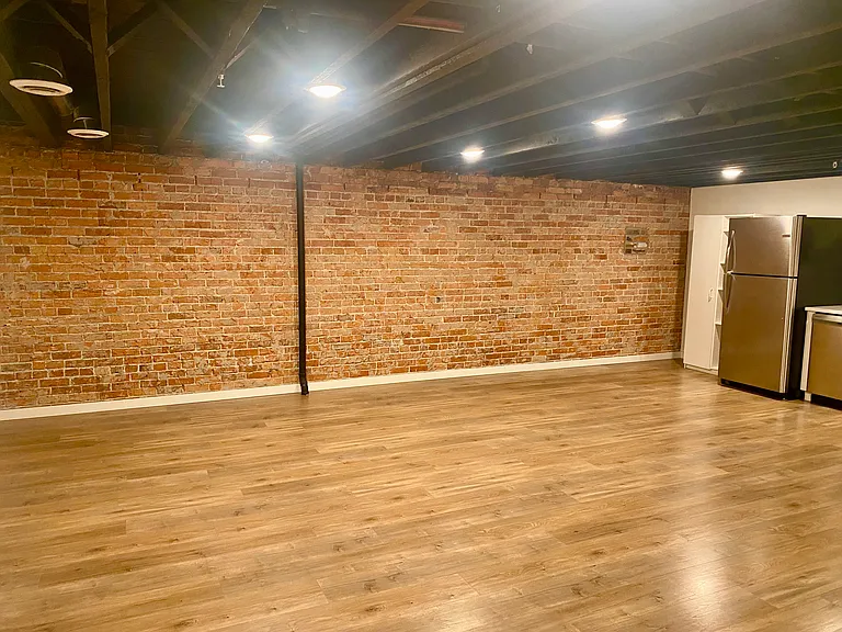 gorgeous brick wall and open rafter ceiling