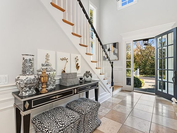 Welcoming light-filled foyer with volume ceiling