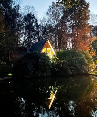 Outside evening view of chalet from across the small pond