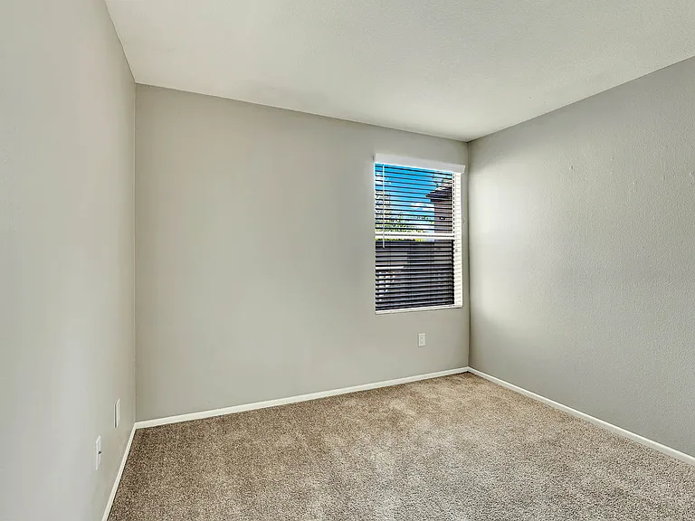 Lake Dianne Apartment Homes Two Bedroom with a carpeted floor and a window with blinds.
