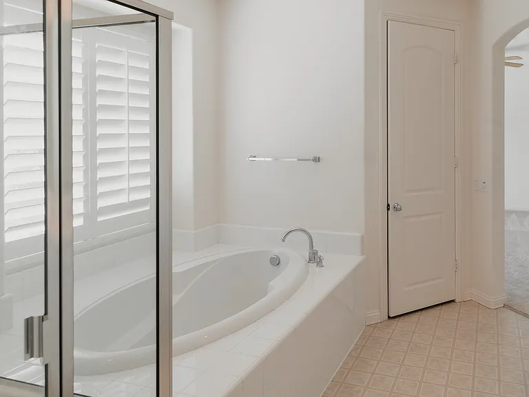view from walk in closet in master bath and door to toilet room