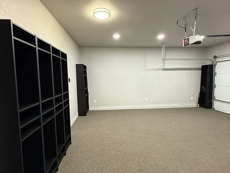 Attached two-car garage with additional storage space.