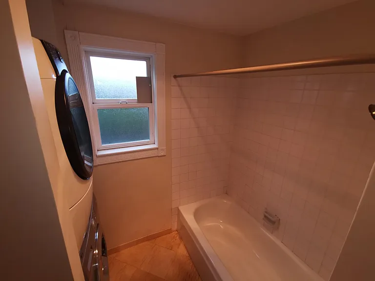 Other angle of 2nd bathroom, which also includes full size washer and dryer.
