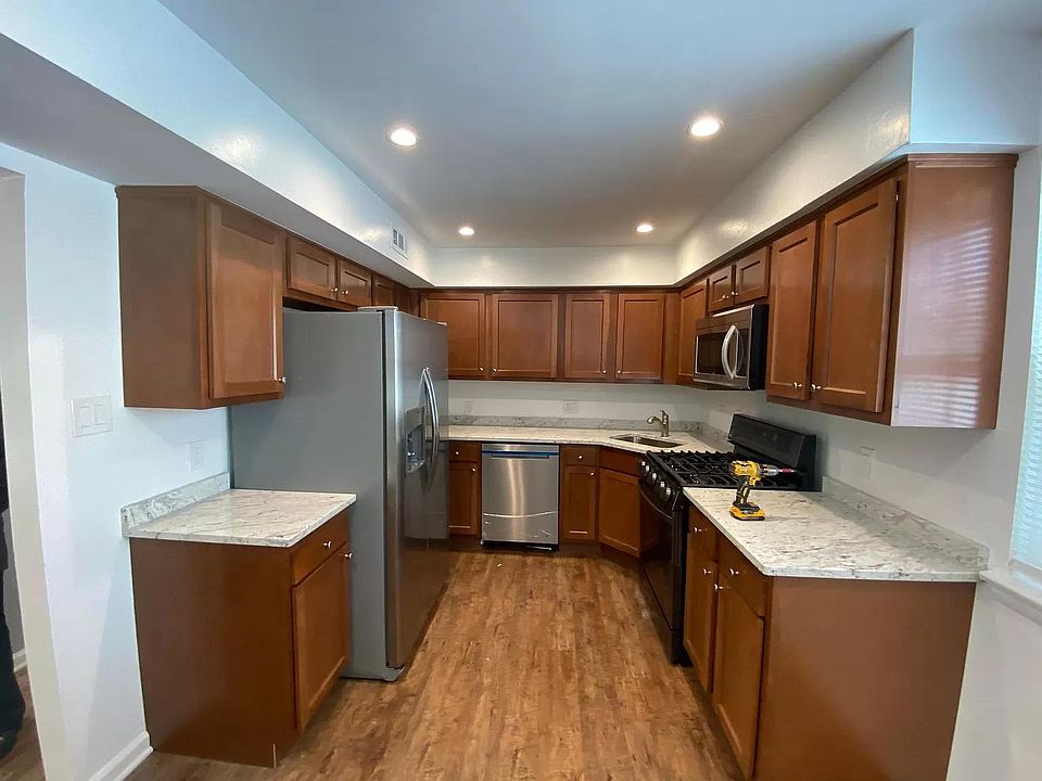 Kitchen with stainless steel appliances and quartz countertops