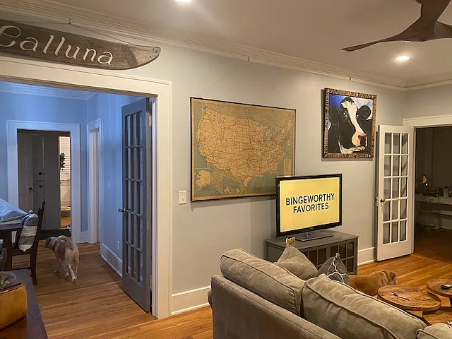 Living Room opens up to dining room with double french doors and also opens up to sunroom with a single french door. Decorative fireplace and tall ceilings with recessed lighting and ceiling fan. Original newly finished hardwood floors.