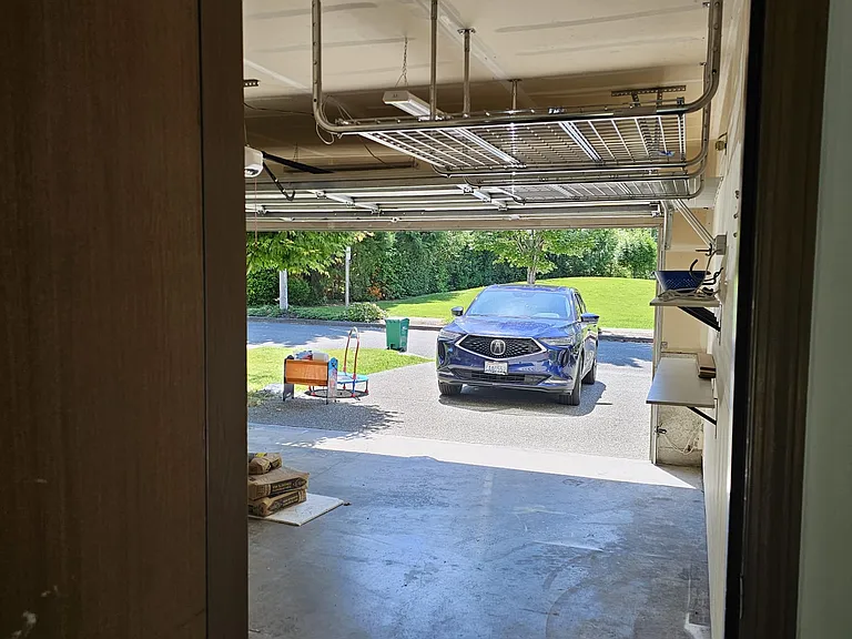 Garage with lot of shelves and storage space.