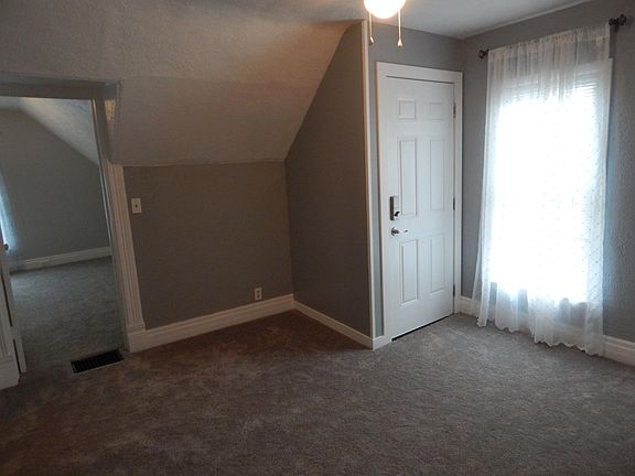 Living room entry into apartment, new carpet, paint, new doo