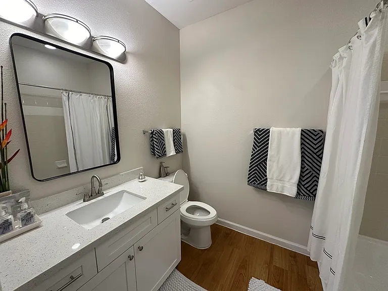 Modern bathroom with elegant lighting, sleek white vanity, and stylish decor for a refreshing ambiance. Modern bathroom with elegant lighting, sleek white vanity, and stylish decor for a refreshing ambiance.