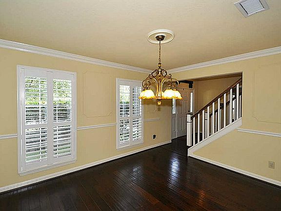 Dining room located directly off kitchen with chair rails & plantation shutters!