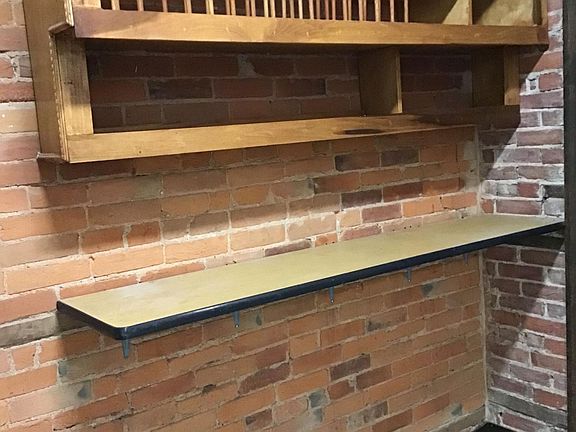 Kitchen breakfast bar and plate storage area
