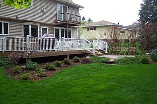View of deck & landscaped yard.