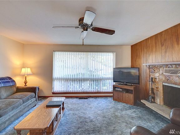 A large picture window pours in natural light.