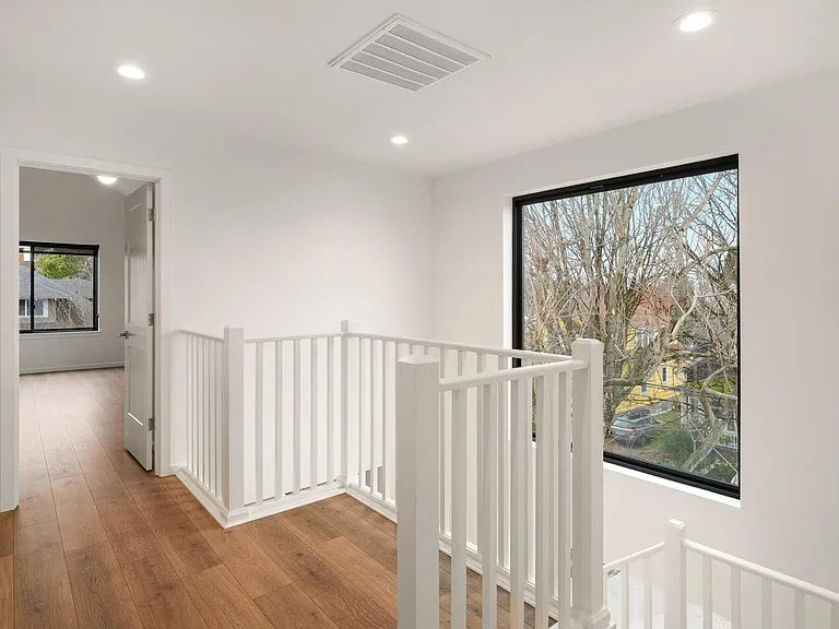 UPPER LEVEL LANDING WITH LARGE WINDOWS