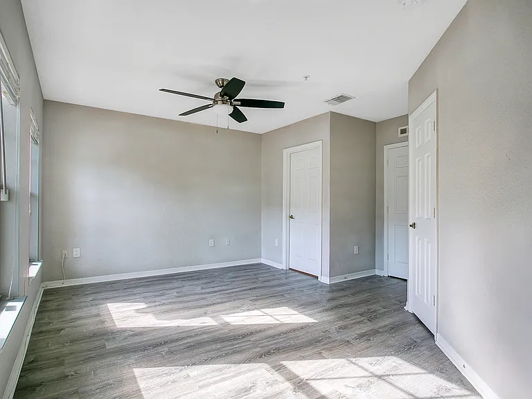 large bedroom with ceiling fans