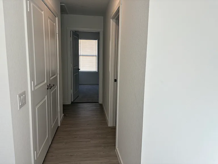 In front of Washter dryer room is bathroom and hallway leading to rest of 3 bedrooms.