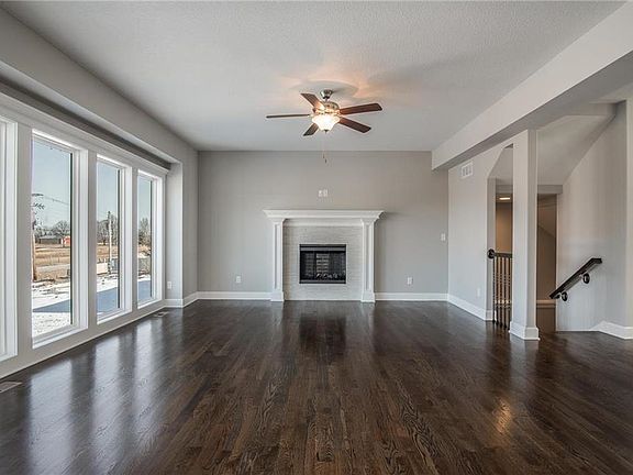 Gorgeous living room with hardwood flooring and custom fireplace.  TV mount over the fireplace.