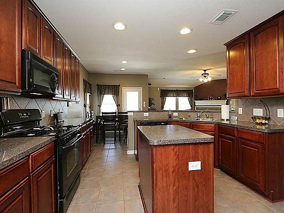 Island Kitchen with 42 inch cabinets and tile floors