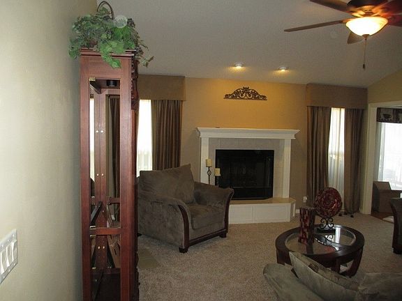 Spacious living room with wood burning fireplace.