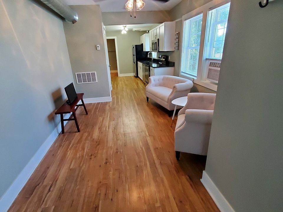Standing in the bedroom doorway looking at the living room.